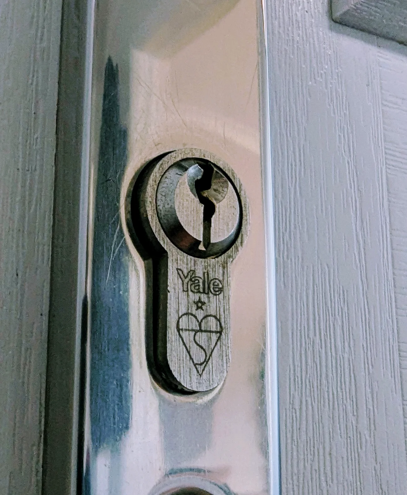 ERA euro cylinder in a silver door plate on a grey timber door
