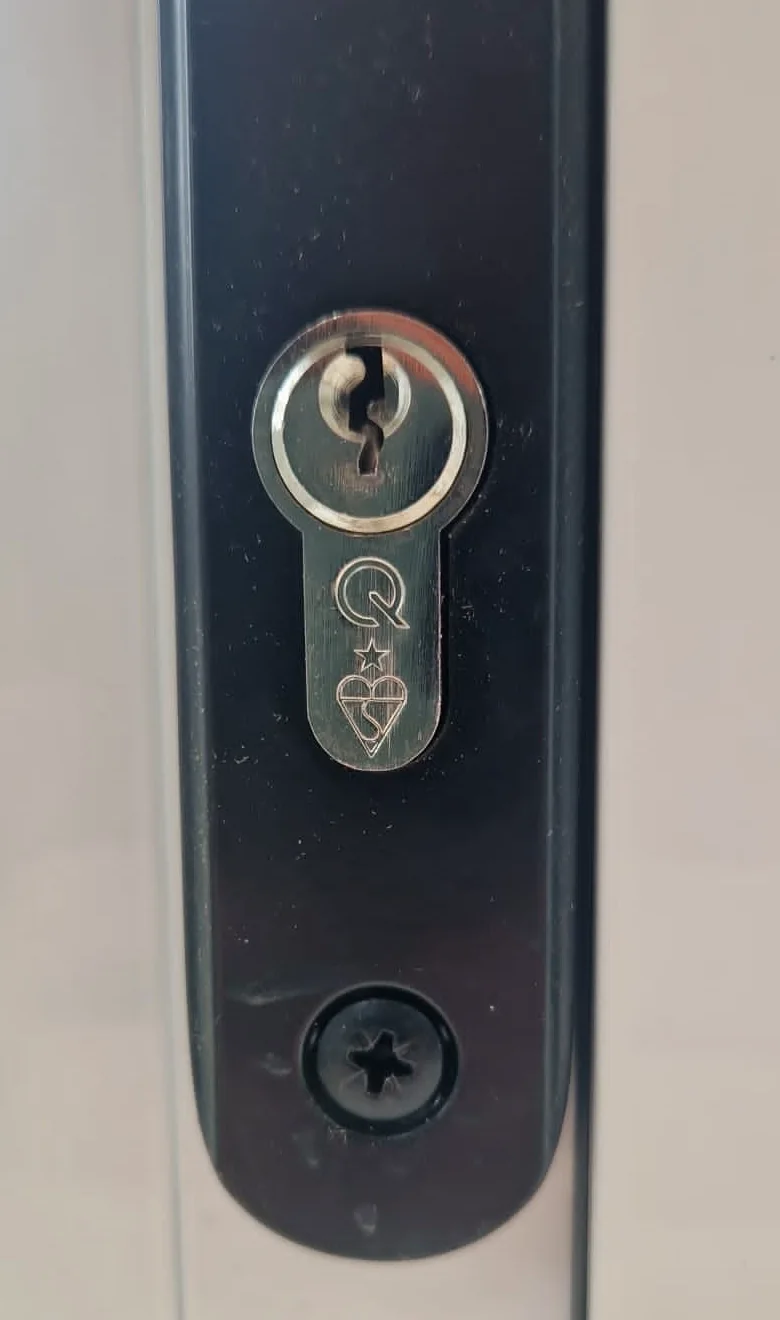 ERA euro cylinder fitted in a black door handle plate
