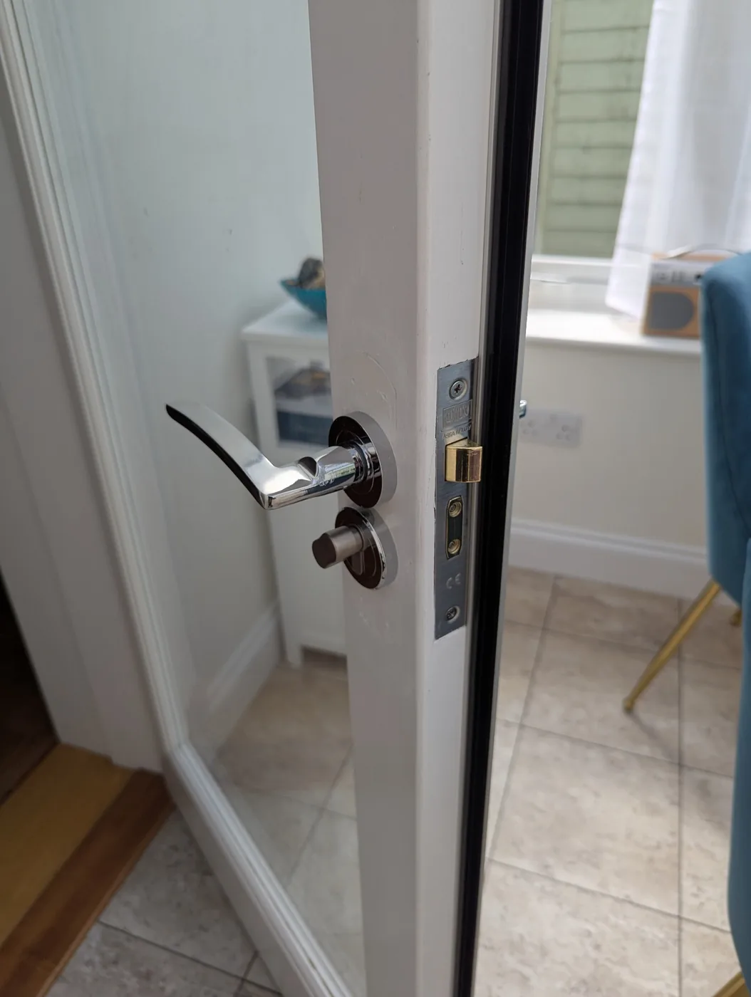 Modern door handle and lockset on a white glazed door after lock and handle work